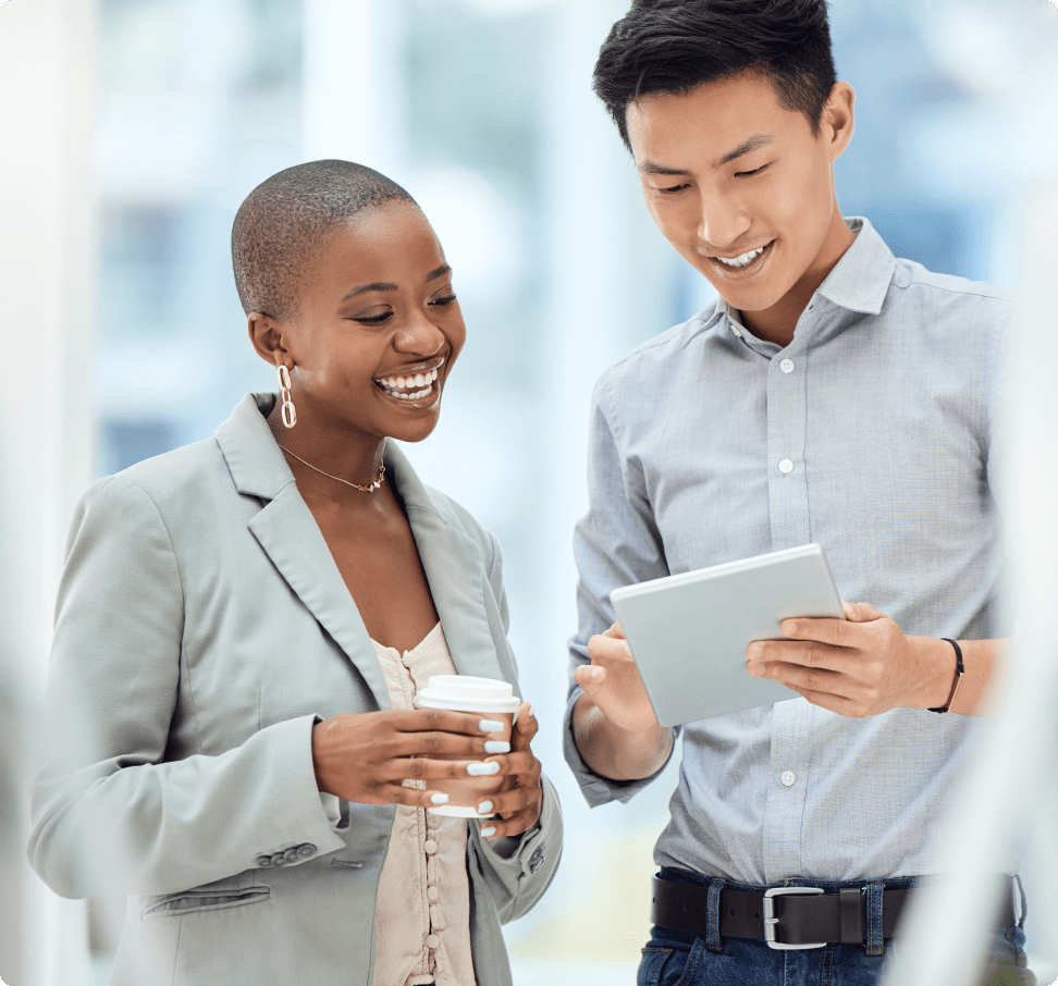 Smiling business man and woman looking at tablet